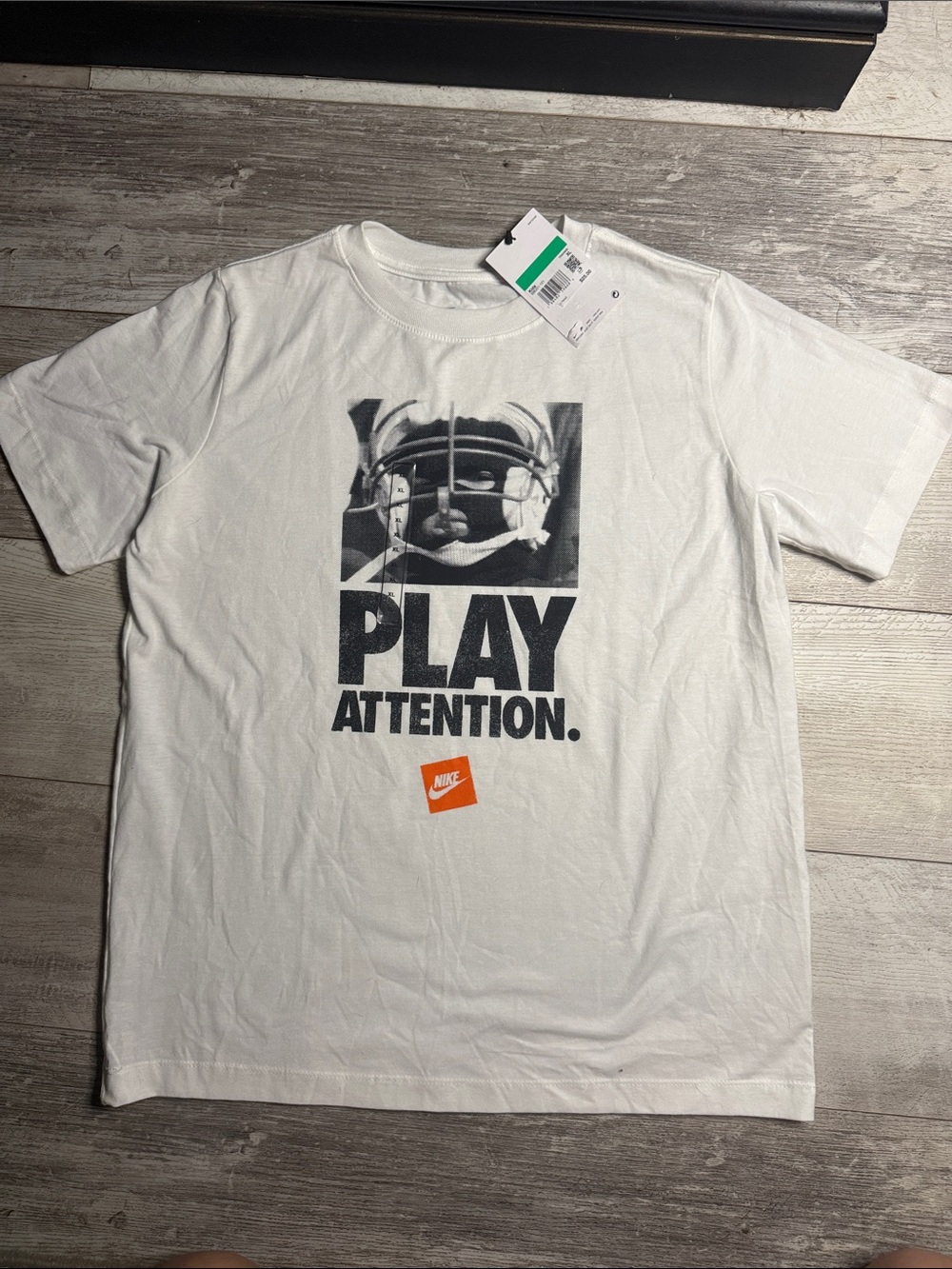 Nike White Graphic 'PLAY ATTENTION' Tee with Black Print and Orange Logo